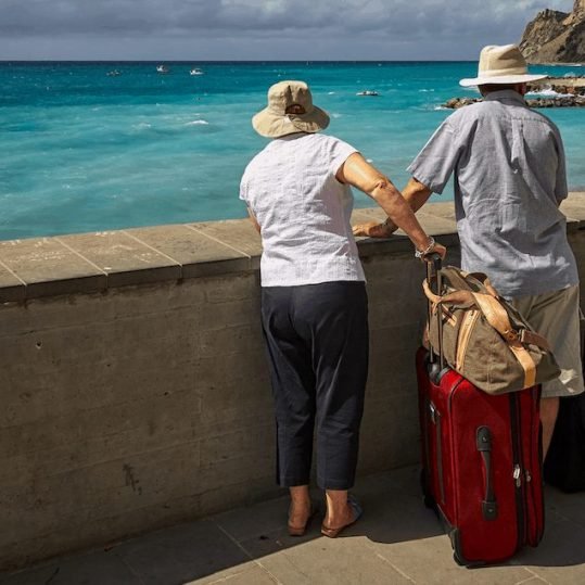 Couple at beach with their luggage